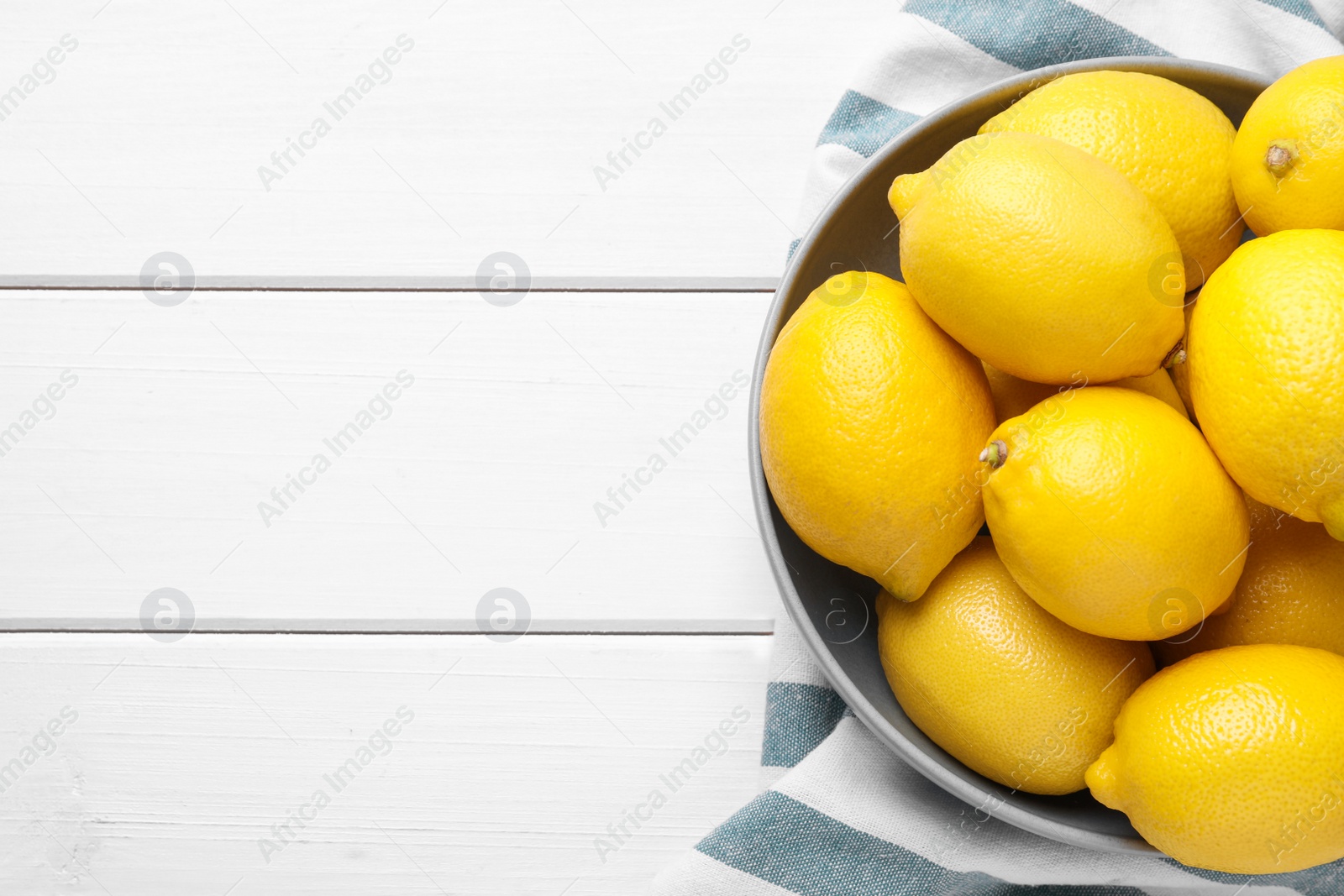 Photo of Many fresh ripe lemons on white wooden table, flat lay. Space for text