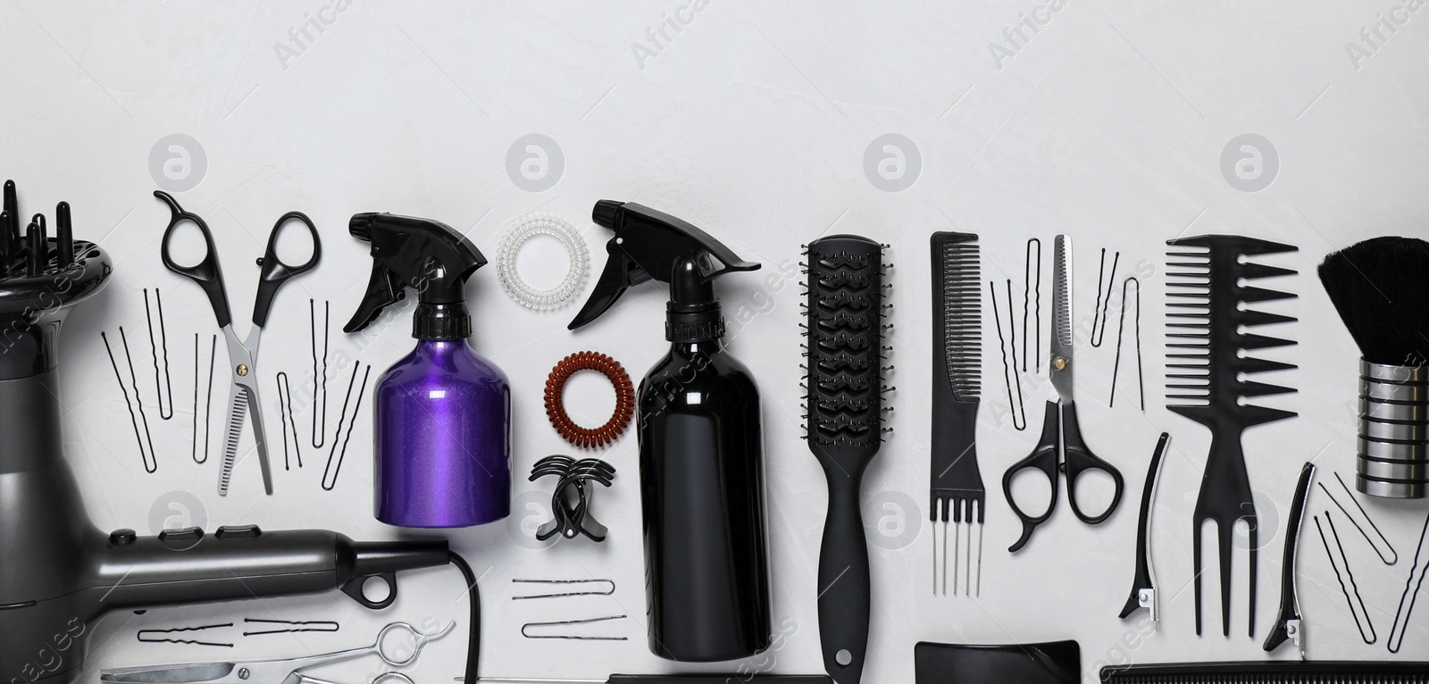 Image of Set of professional hairdresser's tools on light background, flat lay. Banner design