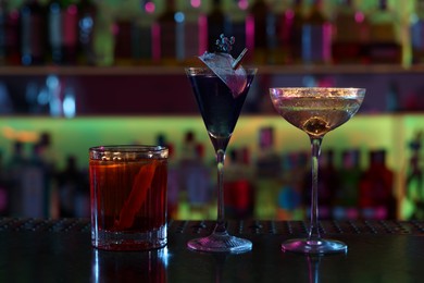 Different fresh alcoholic cocktails on counter in bar
