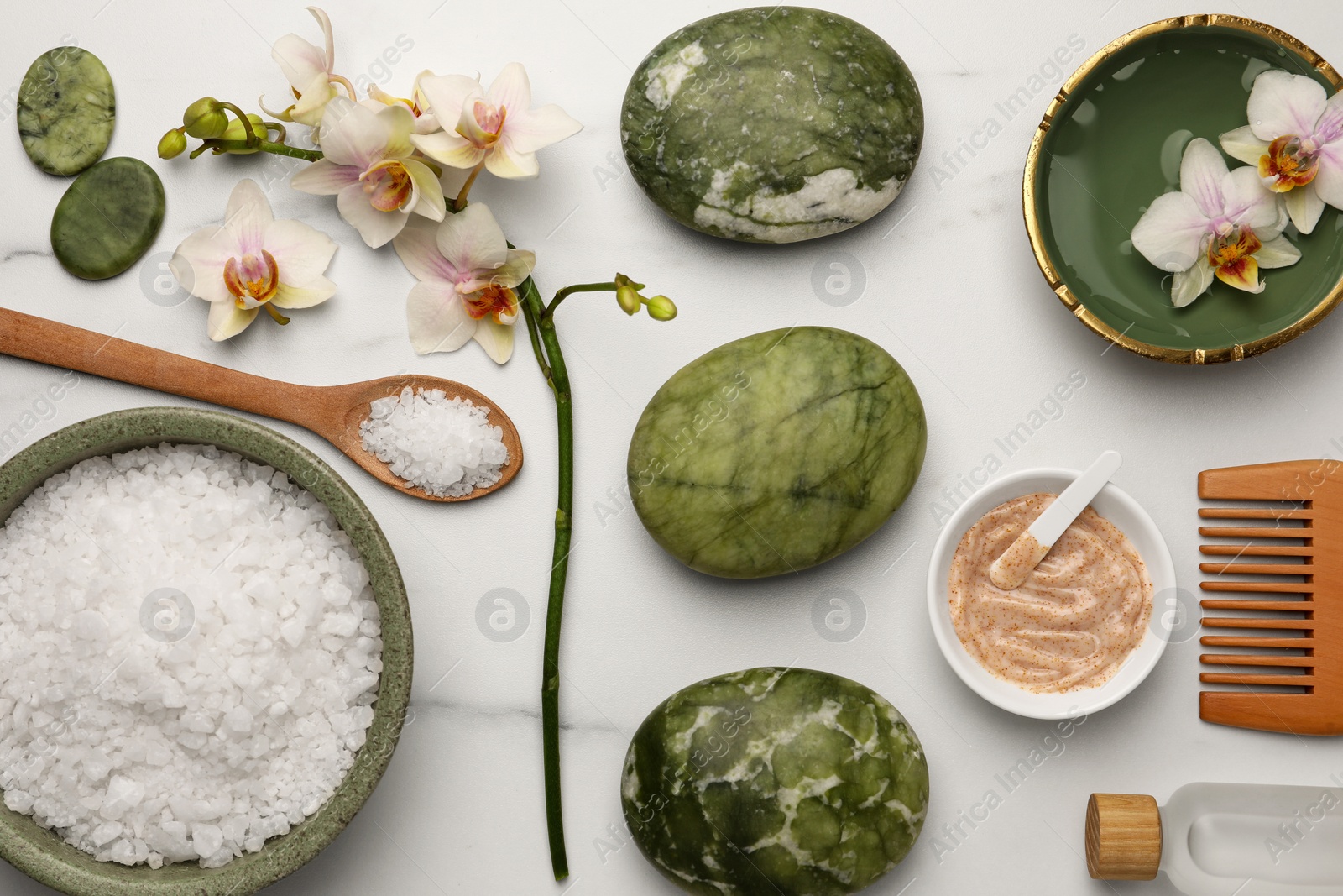 Photo of Flat lay composition with different spa products and flowers on white marble table