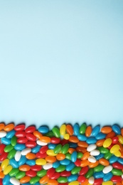 Flat lay composition with delicious jelly beans on color background. Space for text