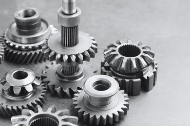 Photo of Different stainless steel gears on light grey background, closeup