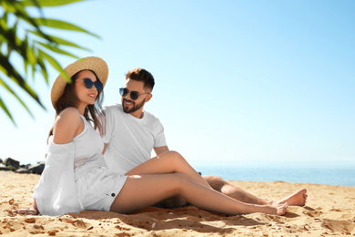 Happy young couple on beach near sea. Honeymoon trip