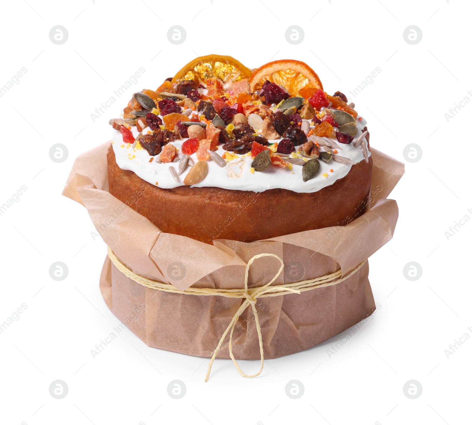 Photo of Traditional Easter cake with sprinkles and dried fruits in parchment paper isolated on white