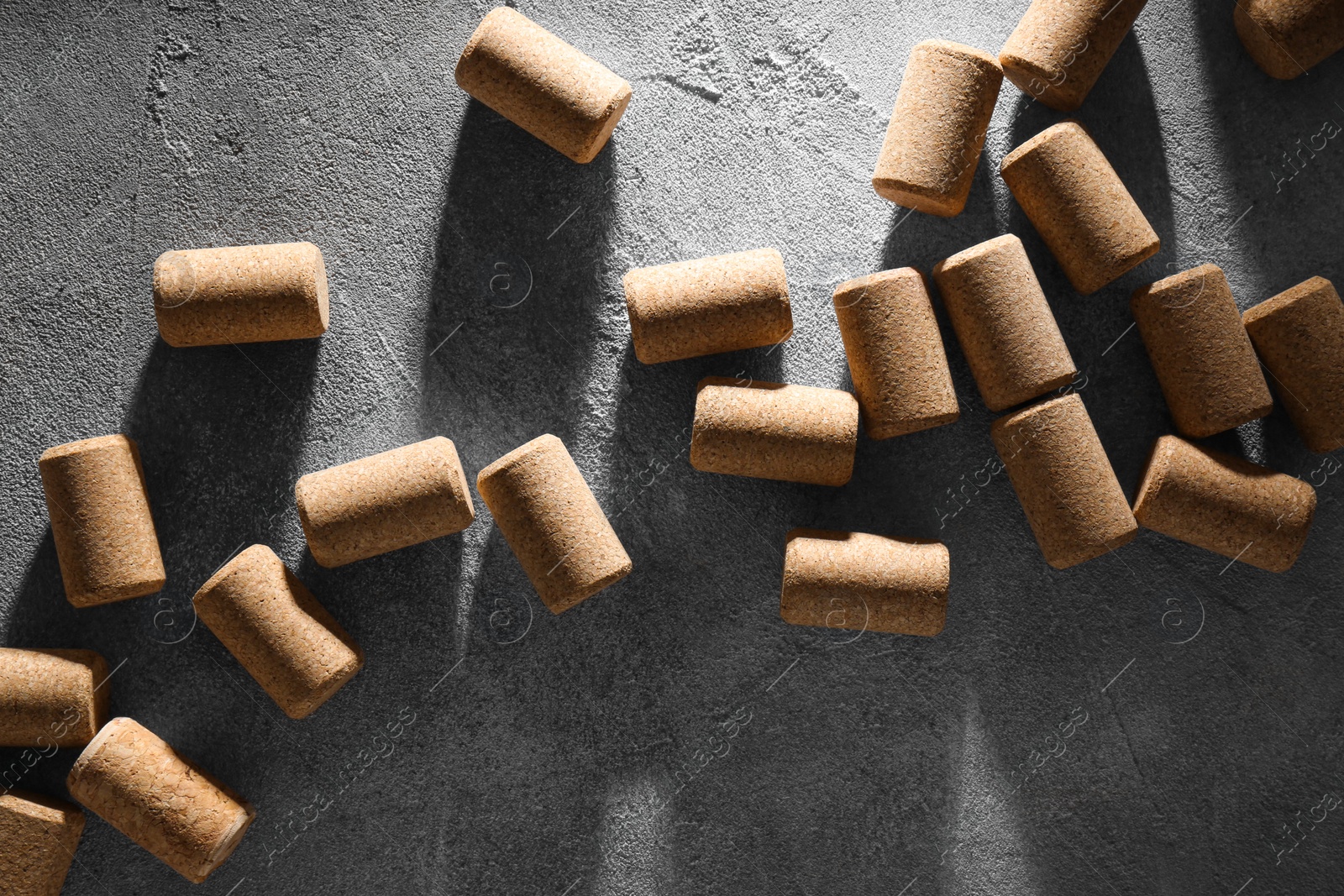 Photo of Wine bottle corks on grey table, flat lay