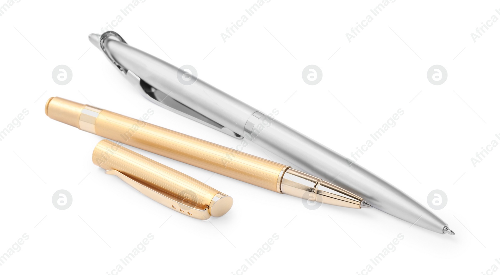Photo of New stylish silver and golden pens isolated on white