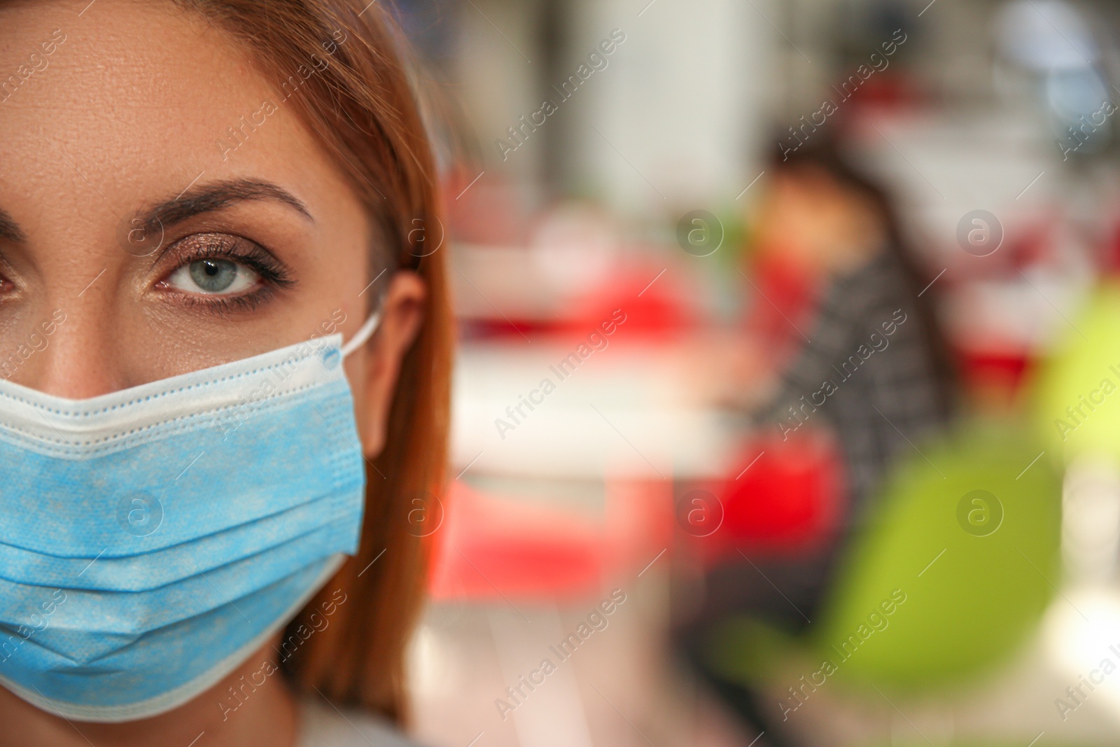 Photo of Woman with medical mask in cafe, space for text. Virus protection