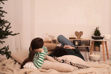 Photo of Couple watching movie via video projector at home