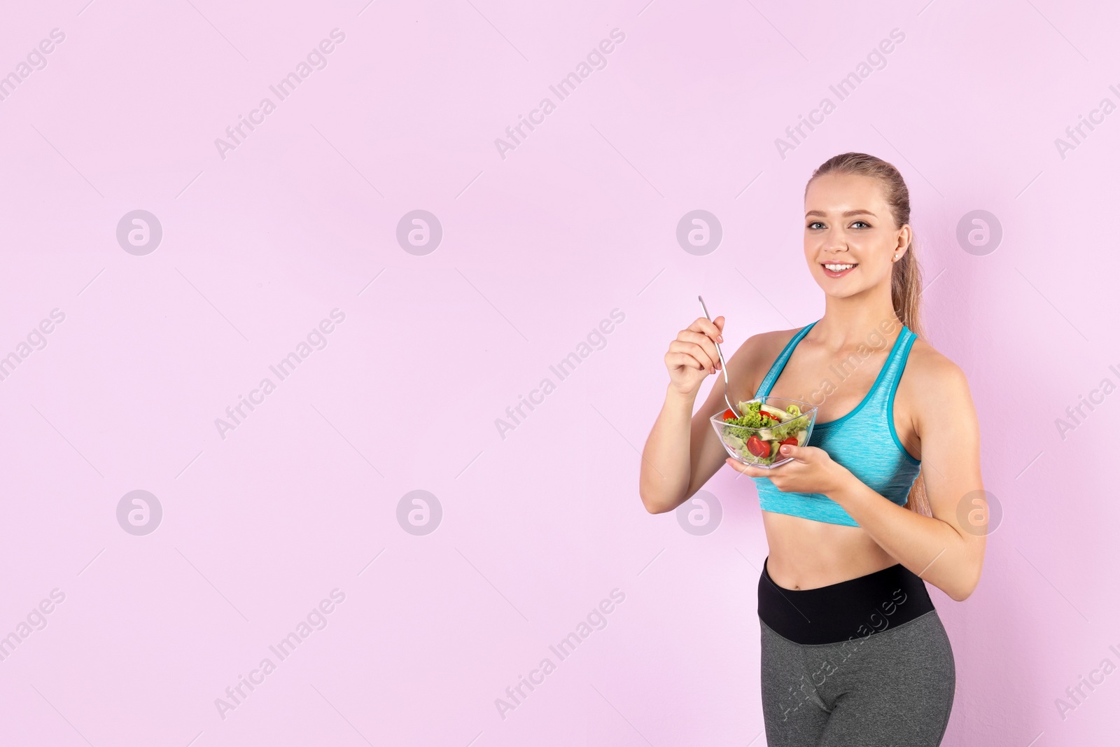 Photo of Young woman with salad on color background. Healthy diet