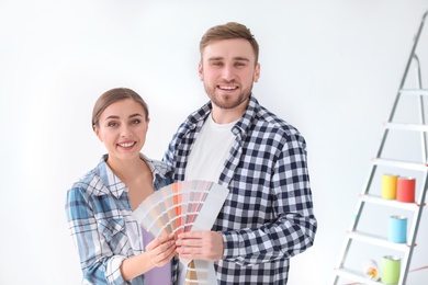 Photo of Young couple with color palette on white background