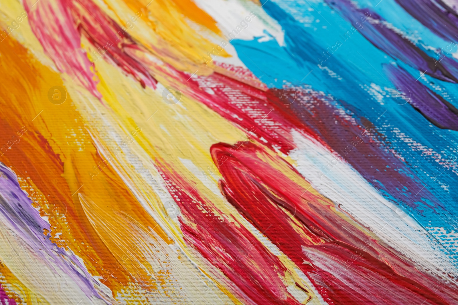 Photo of Beautiful strokes of colorful oil paints on white canvas as background, closeup