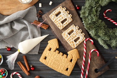 Photo of Flat lay composition with parts of gingerbread parts on black wooden table