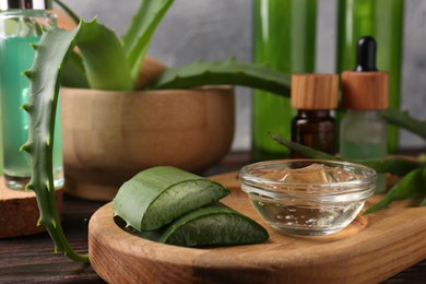 Homemade aloe gel and fresh ingredients on wooden table, closeup