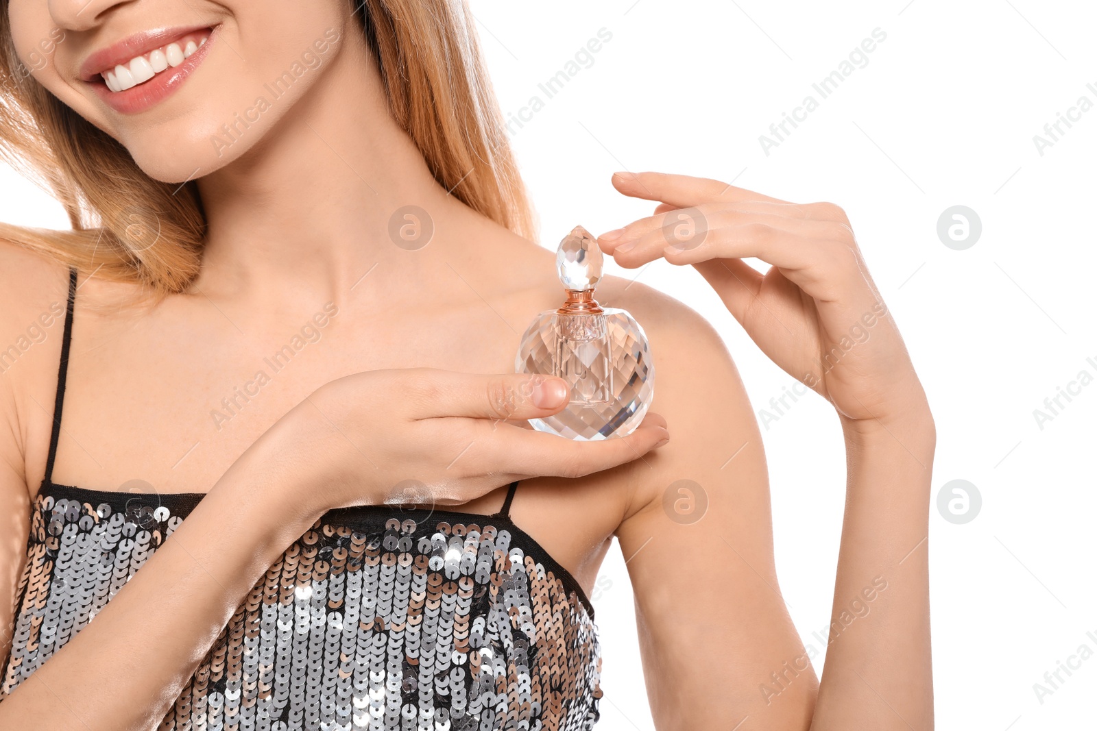 Photo of Young woman with bottle of perfume on white background, closeup