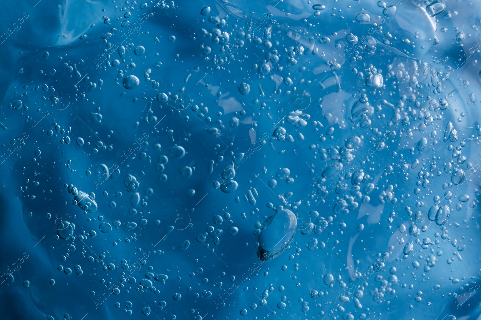 Photo of Texture of light blue shower gel as background, top view