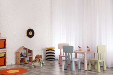 Photo of Modern child room interior with table and chairs