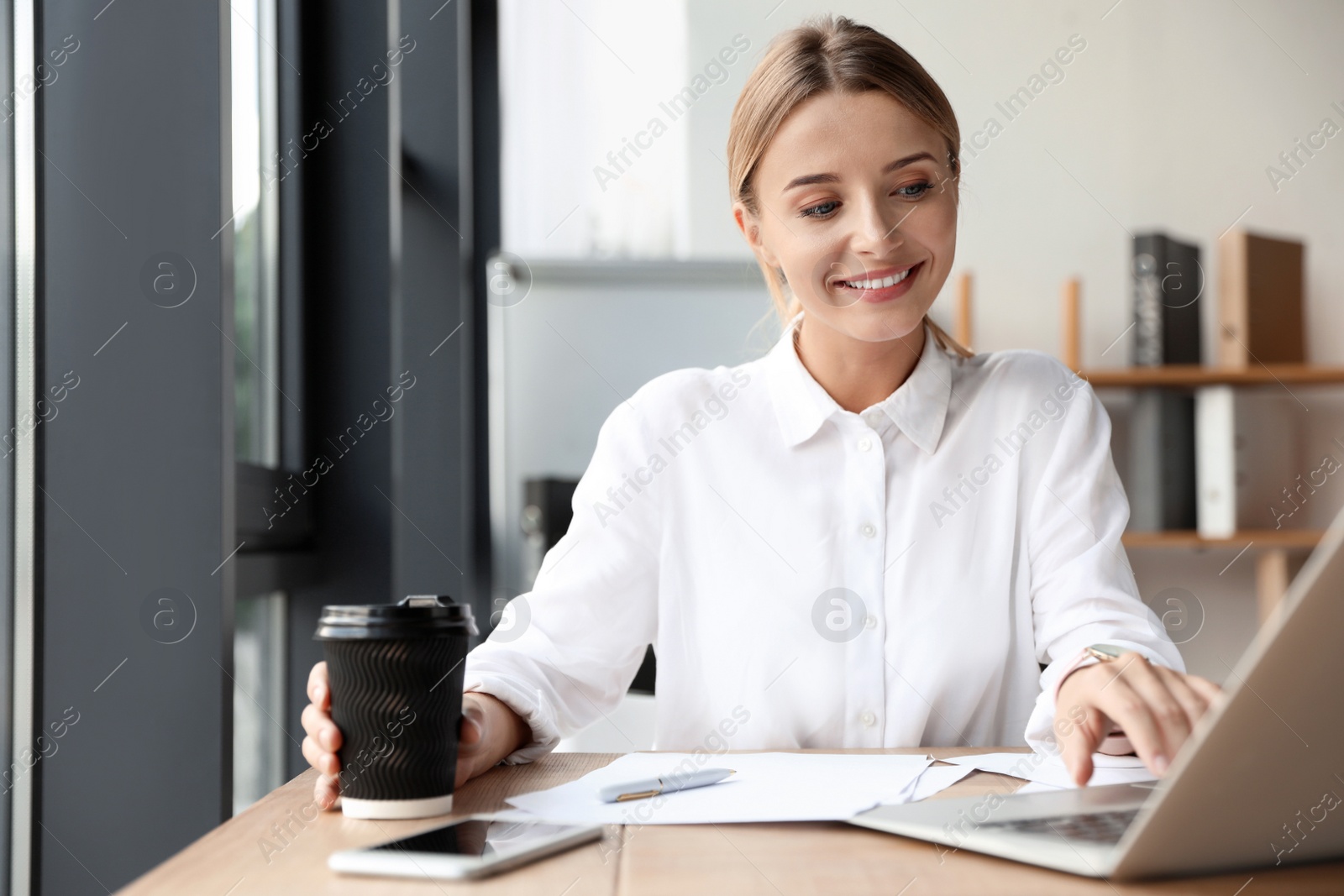 Photo of Female business trainer working with laptop in office