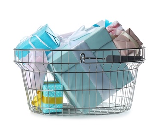 Photo of Shopping basket full of gift boxes on white background