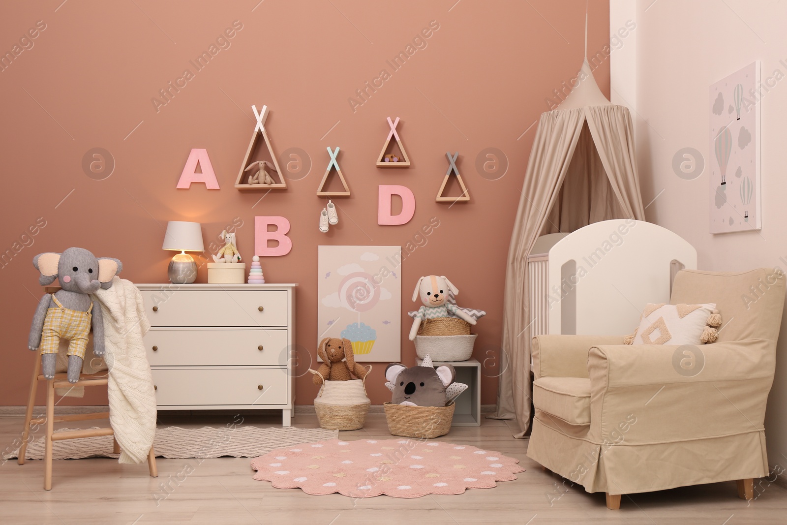 Photo of Baby room interior with stylish furniture and comfortable crib