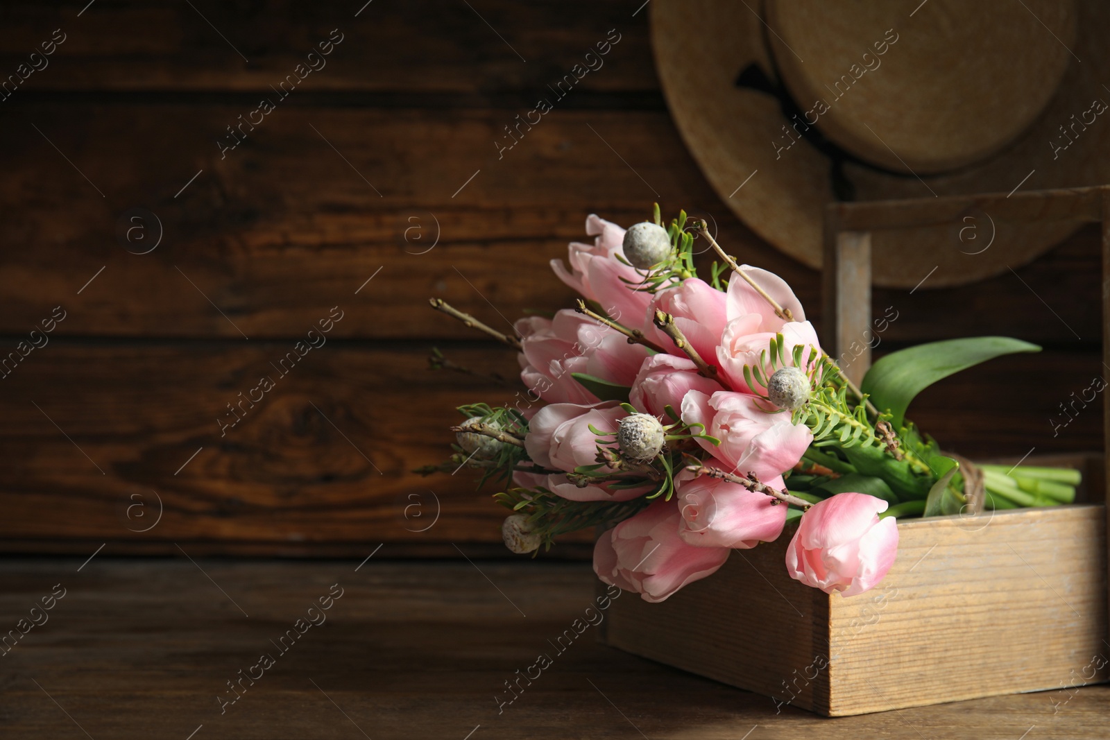 Photo of Beautiful bouquet of spring pink tulips on wooden table. Space for text