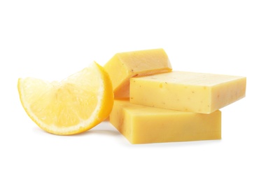 Handmade soap bars and lemon on white background