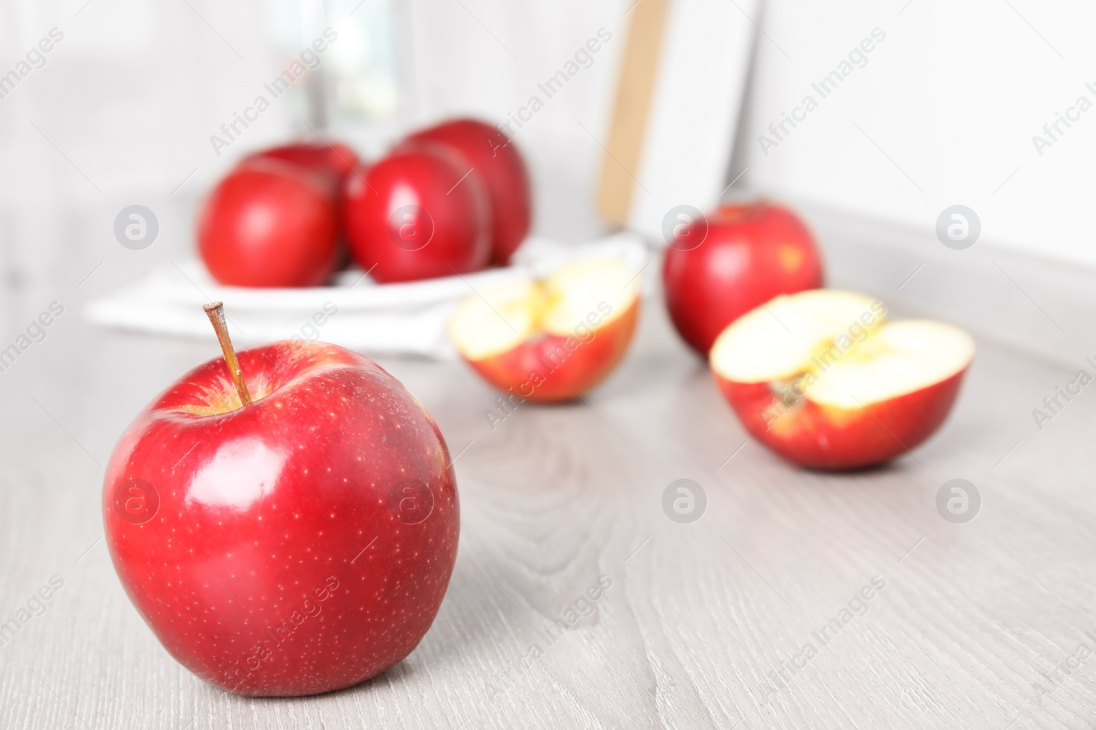 Photo of Ripe juicy red apples on white wooden table indoors