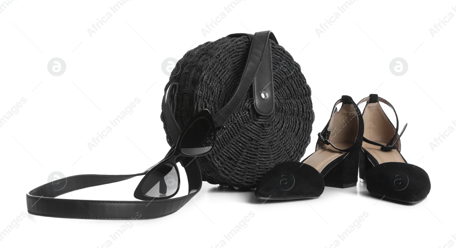 Photo of Stylish black handbag with shoes and sunglasses isolated on white