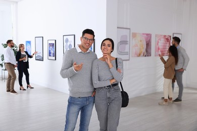 Happy couple at exhibition in art gallery