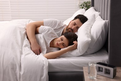 Photo of Lovely couple sleeping together in bed at home