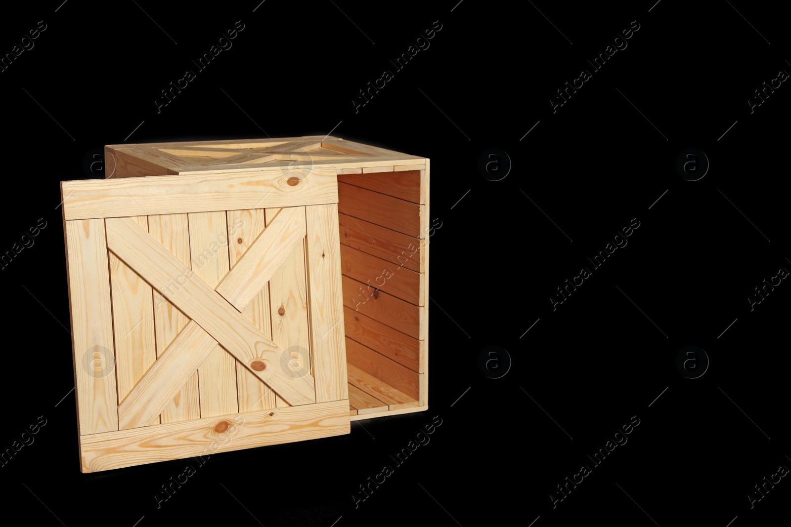 Photo of Wooden crate on black background. Space for text