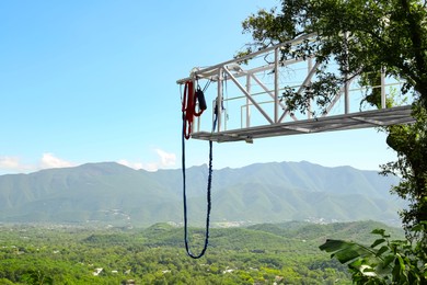 Photo of Bungee jumping tower against beautiful mountain landscape