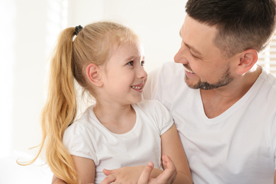 Photo of Dad and daughter spending time together at home. Happy Father's Day