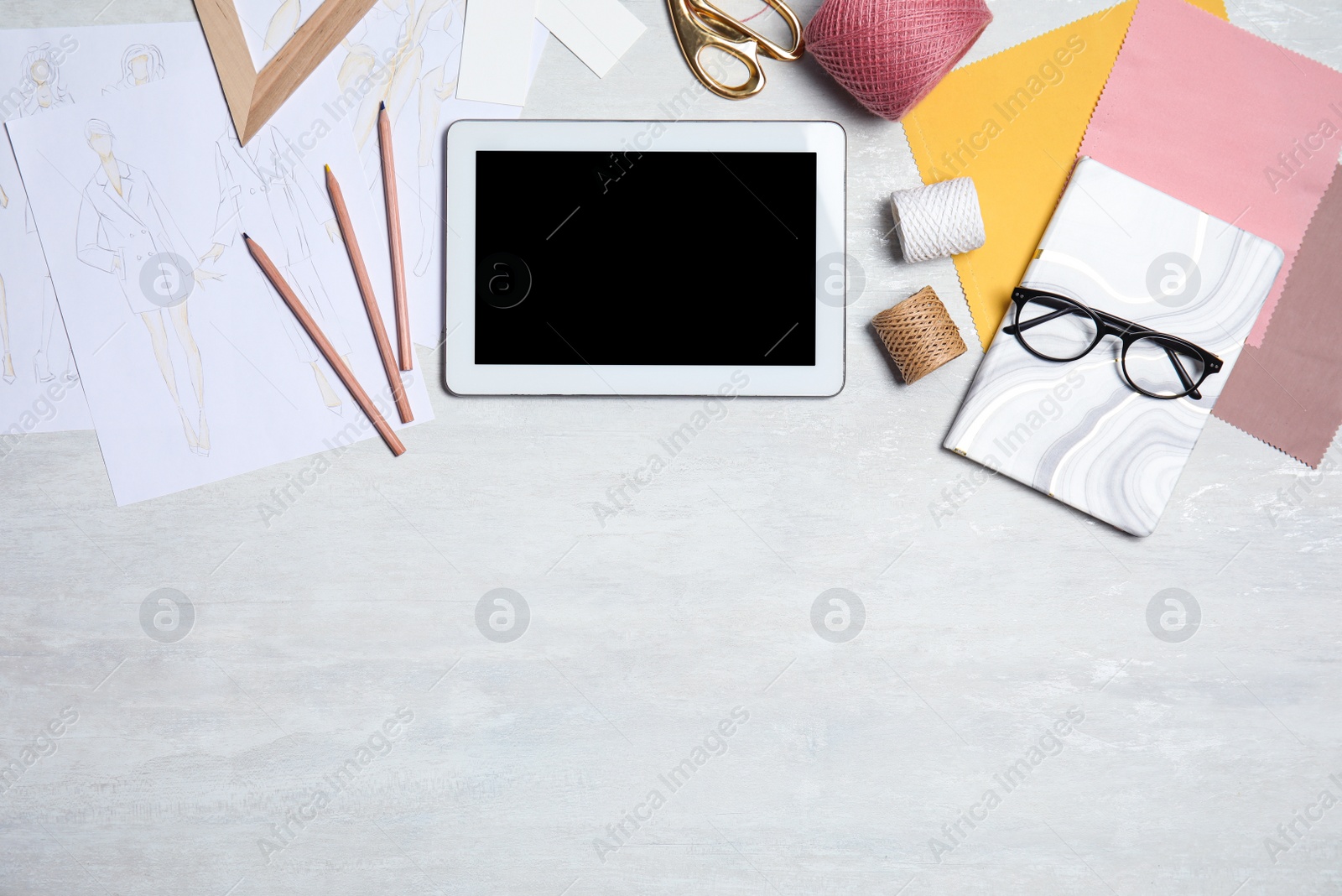 Photo of Flat lay composition with modern tablet and accessories on white table, space for text. Designer's workplace