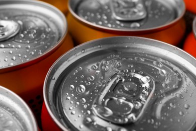 Photo of Energy drinks in wet cans, closeup. Functional beverage