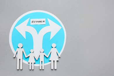 Word Divorce, arrows and paper cutout of family on light grey background, flat lay with space for text