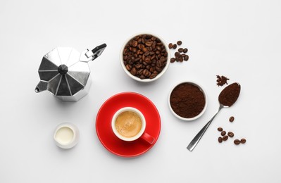 Flat lay composition with coffee grounds and roasted beans on white background