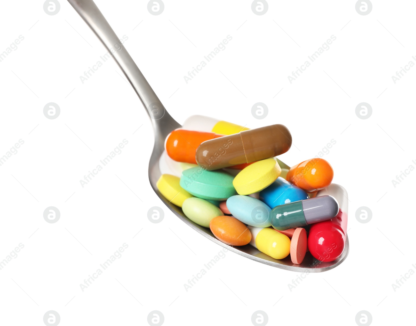 Photo of Different colorful pills in spoon isolated on white