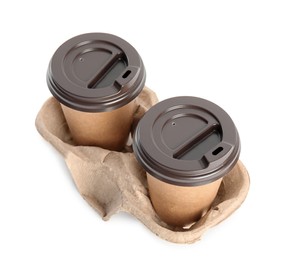 Takeaway paper coffee cups in cardboard holder on white background