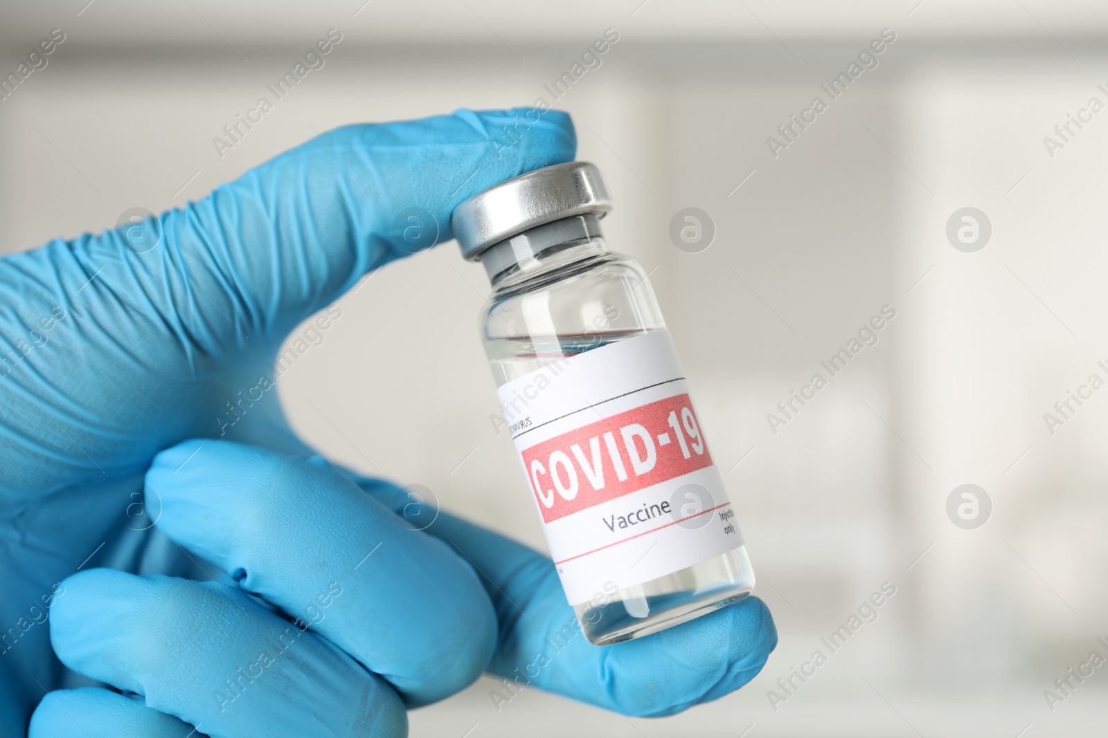 Photo of Doctor with coronavirus vaccine in laboratory, closeup