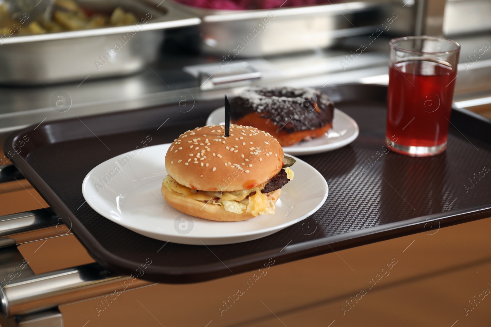 Photo of Plastic tray with tasty food near serving line in school canteen