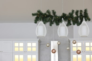 Photo of Beautiful Christmas decor in kitchen. Interior design