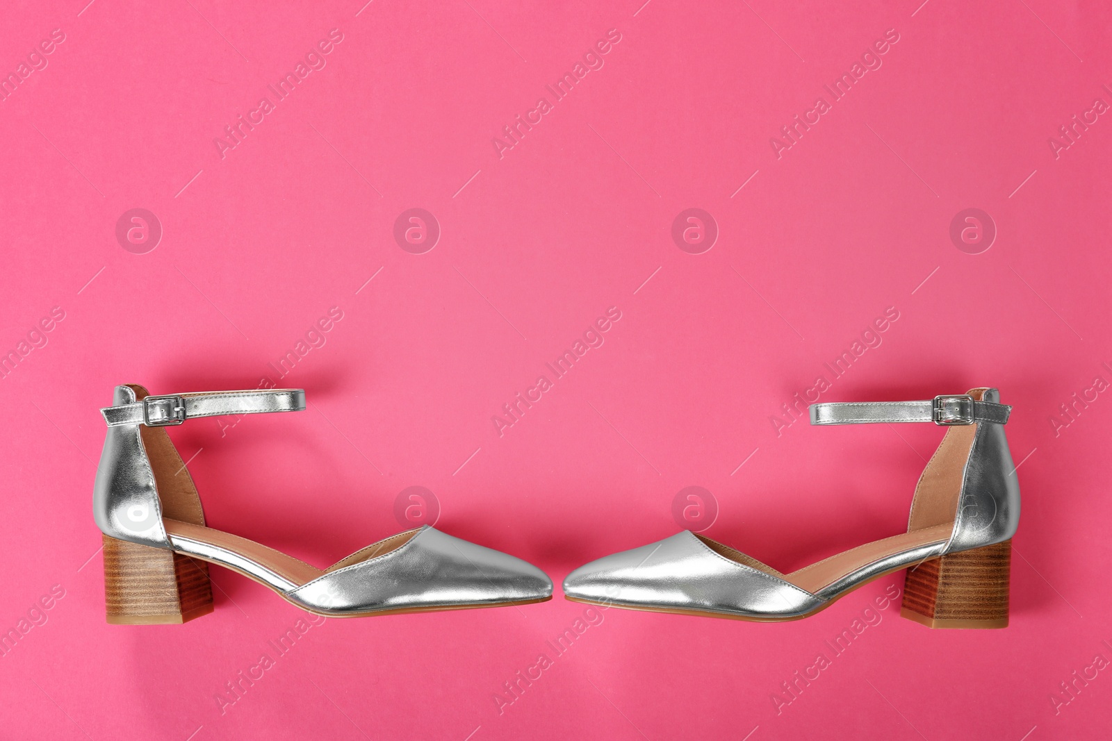 Photo of Pair of female shoes on color background, top view