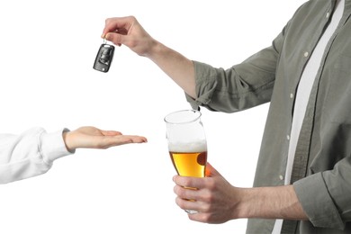 Man with glass of alcoholic drink giving car key to woman on white background, closeup. Don't drink and drive concept