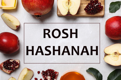 Image of Frame of honey, apples and pomegranates on white table, flat lay. Rosh Hashanah holiday