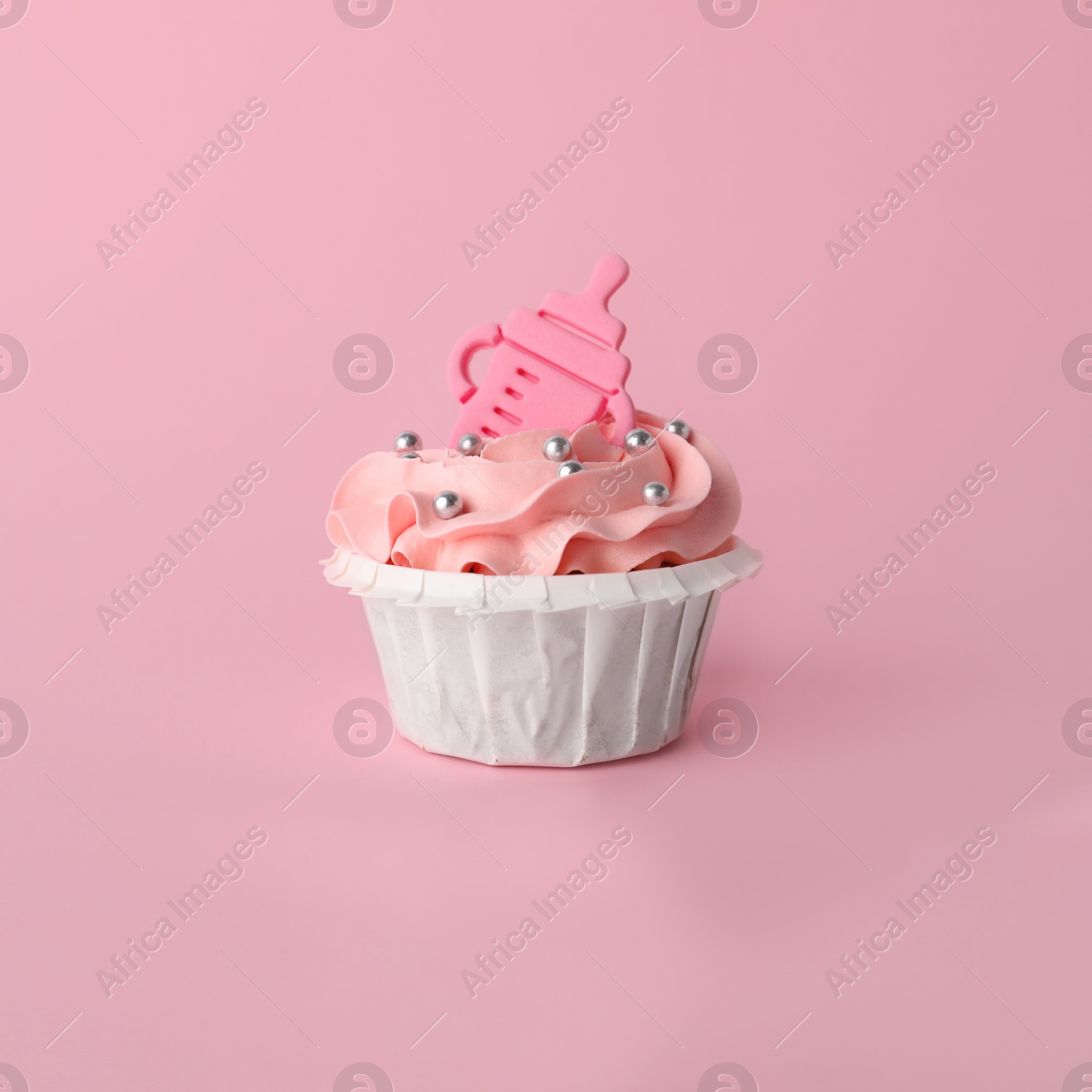 Photo of Baby shower cupcake with topper on pink background