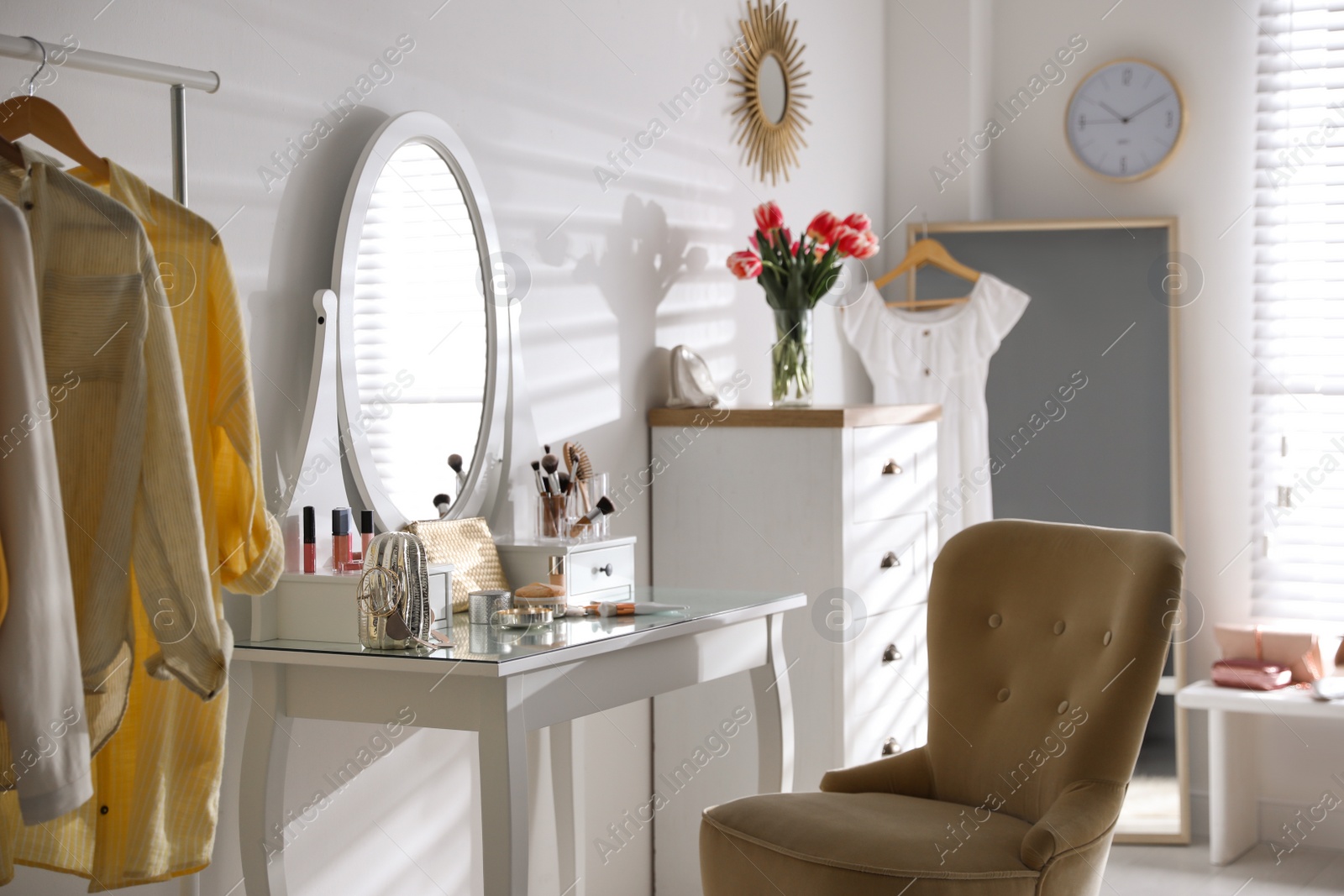 Photo of Stylish room interior with elegant dressing table and comfortable chair