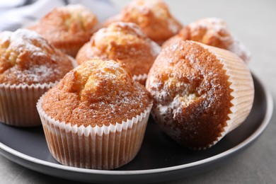 Photo of Delicious sweet muffins on grey table, closeup