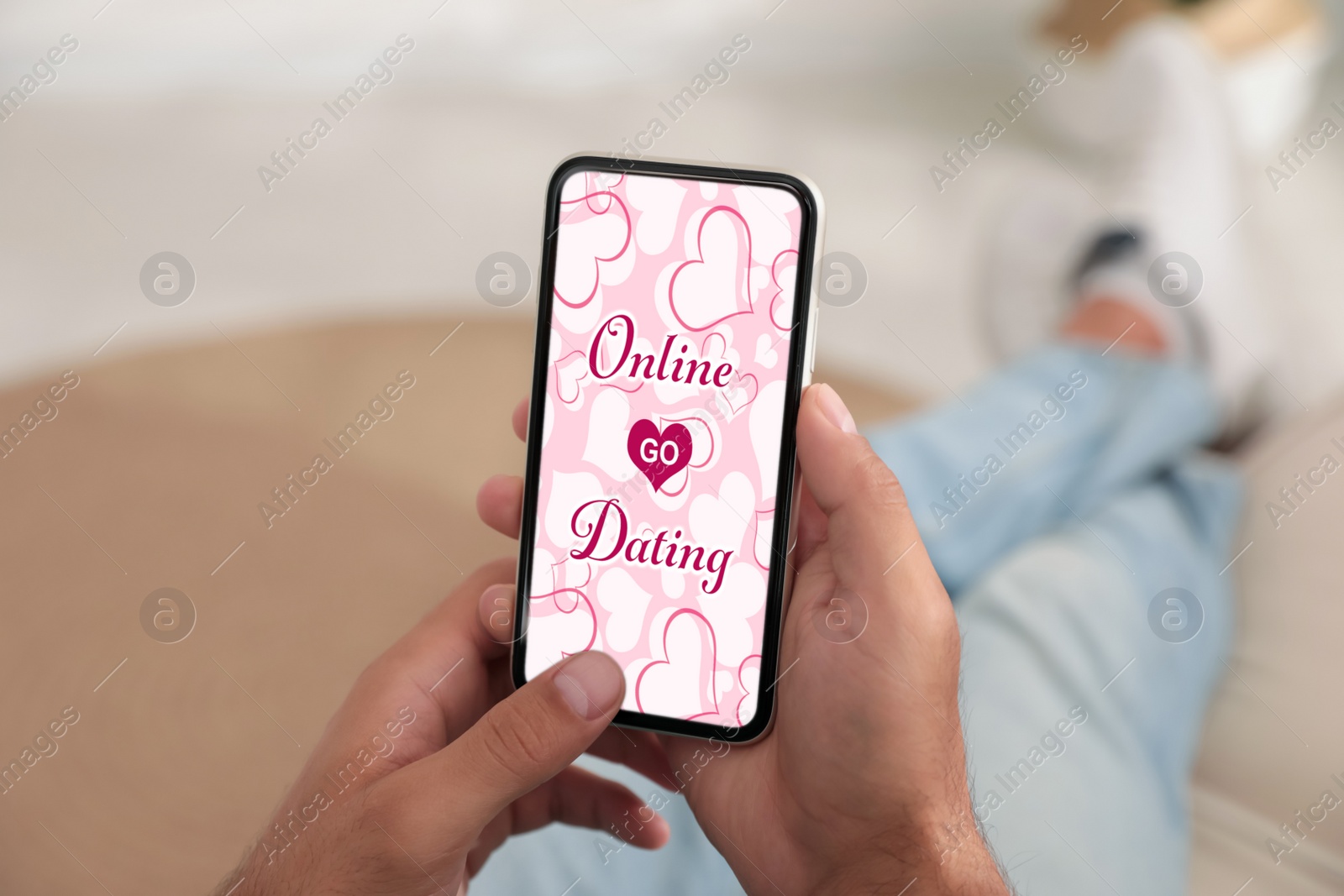 Image of Man visiting dating site via smartphone indoors, closeup