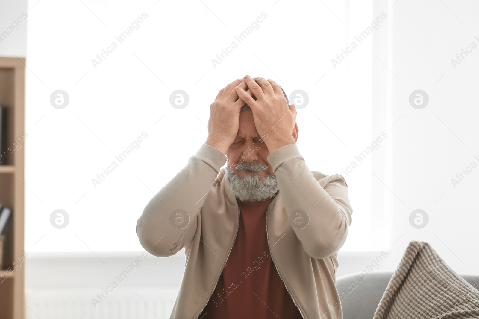 Photo of Senior man in state of depression indoors