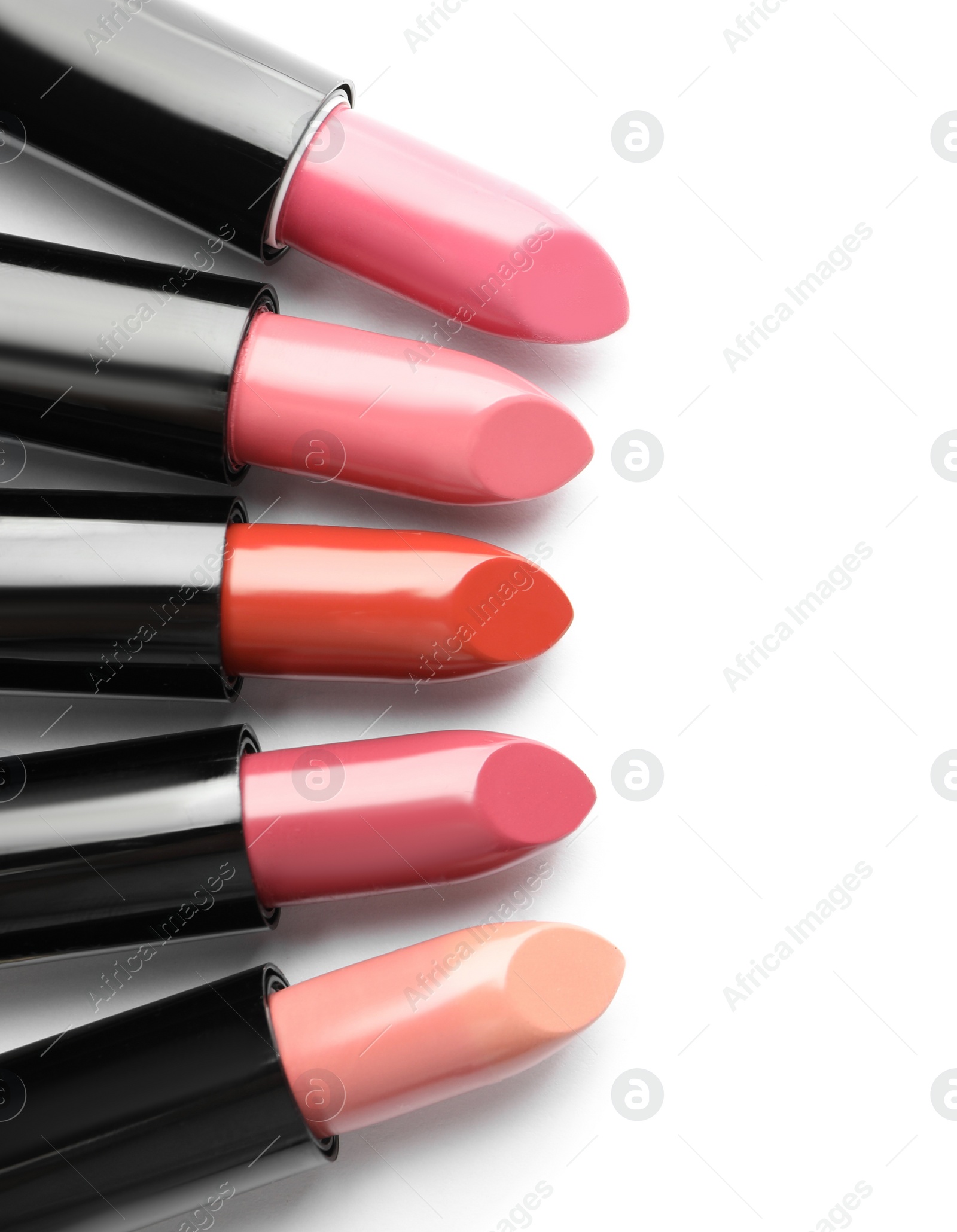 Photo of Different lipsticks on white background, top view